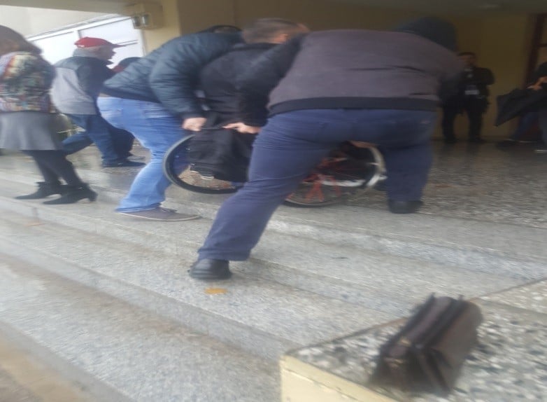 Iš Ukmergės rinkimų apylinkės. Žmogus rateliuose užnešamas laiptais dviejų vyrų/ LNF nuotr.